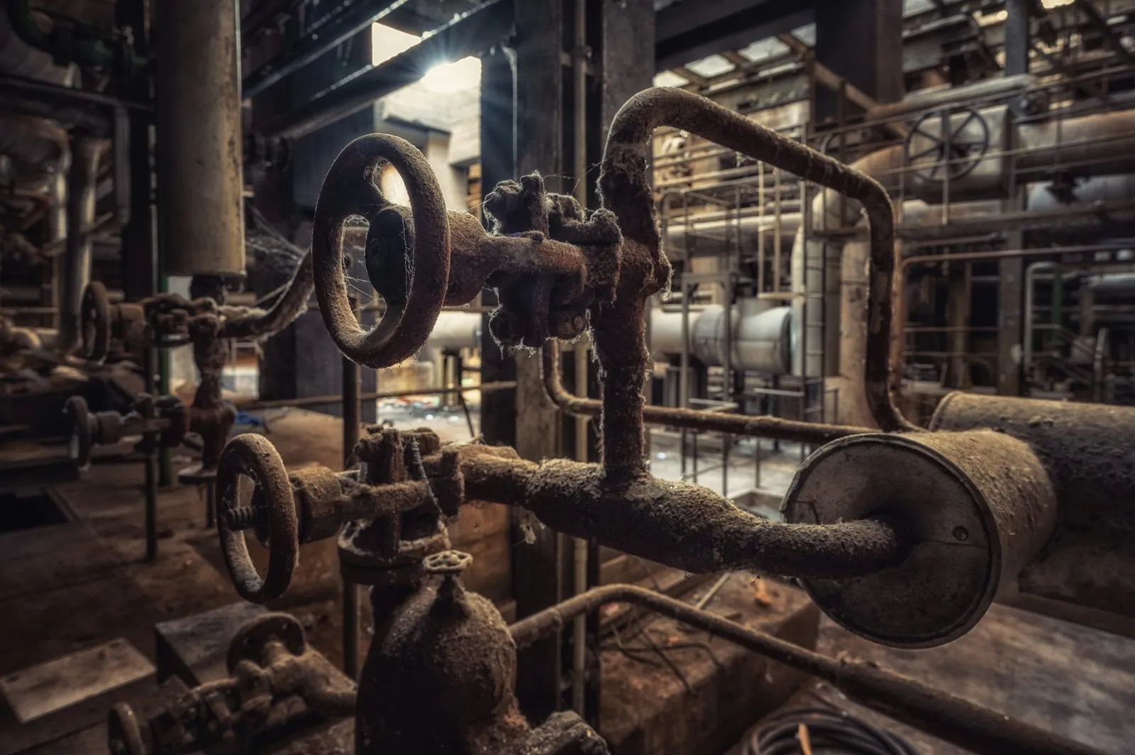 Process valves, gauges, and pipe racks inside a chemical plant