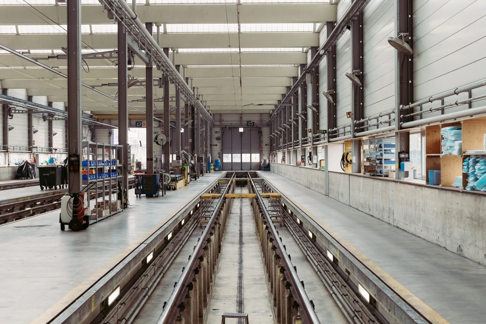 CNC milling cells and an overhead crane on a discrete manufacturing shop floor