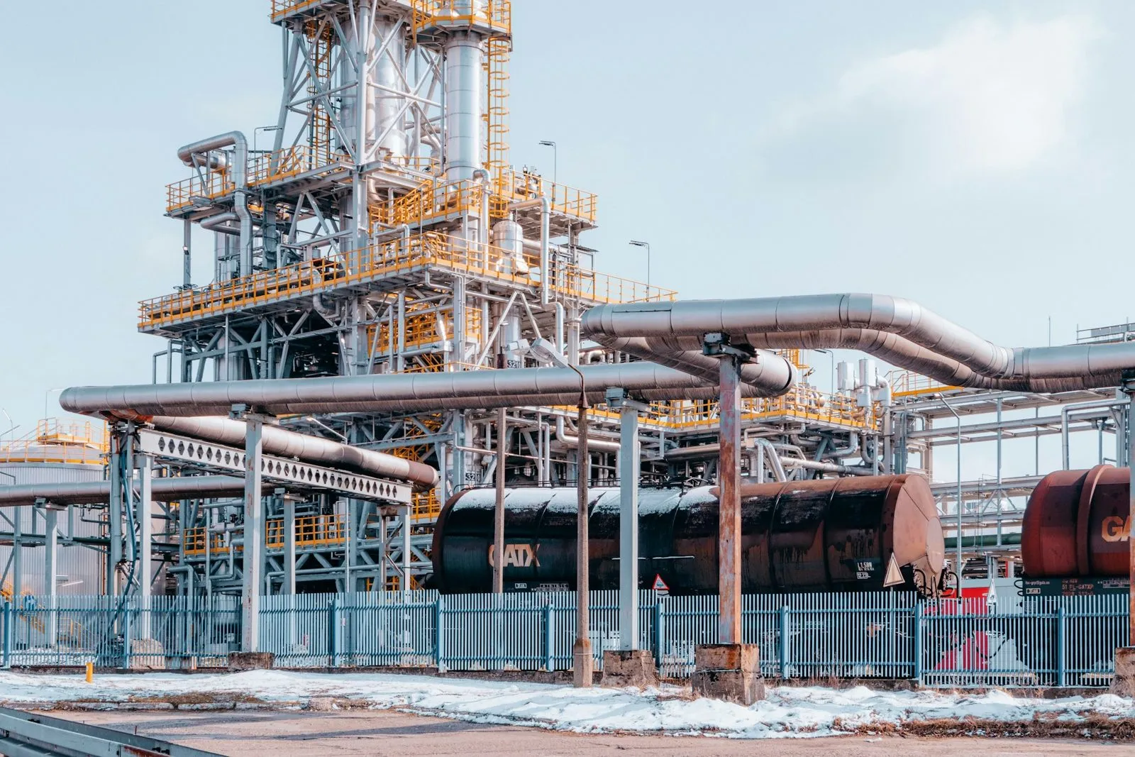 Daylight view of distillation columns and pipe racks at a refinery